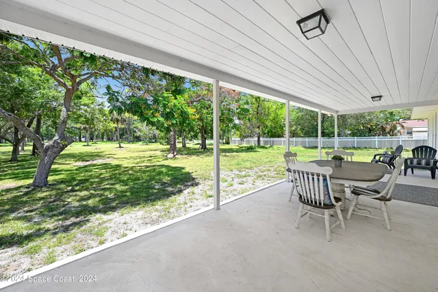 a view of a yard with furniture and garden