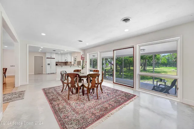 a view of a dining room with furniture window and outside view