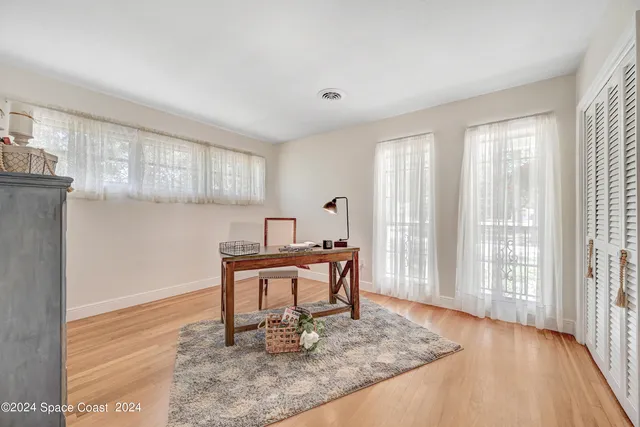 a dining room with wooden floor and a window