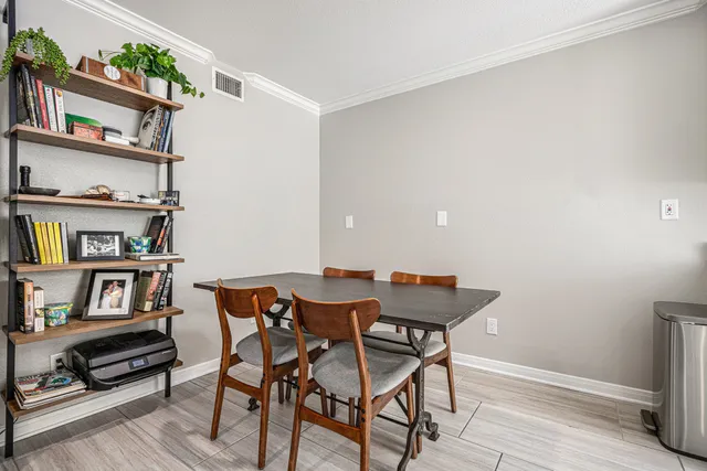 a view of a dining room with furniture and a book shelf
