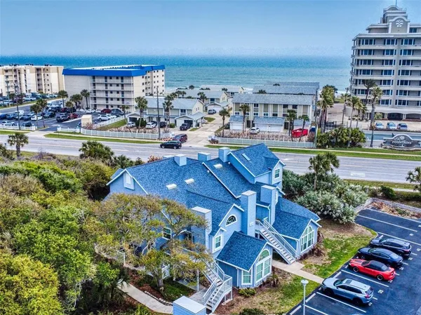 a view of multiple houses with outdoor seating