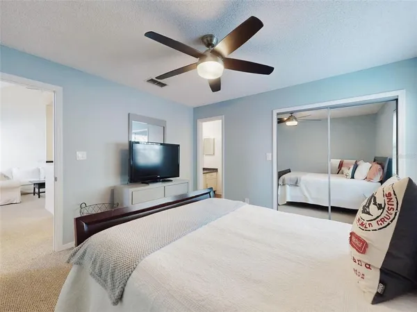 a bedroom with a bed and a flat screen tv