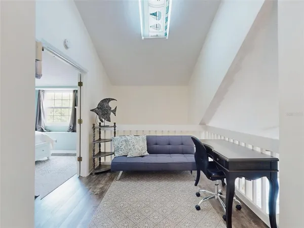 a bedroom with furniture and a window