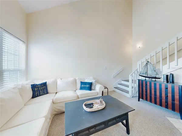 a living room with furniture and a table with wooden floor