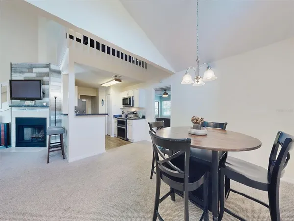 a view of a dining room with furniture and a chandelier