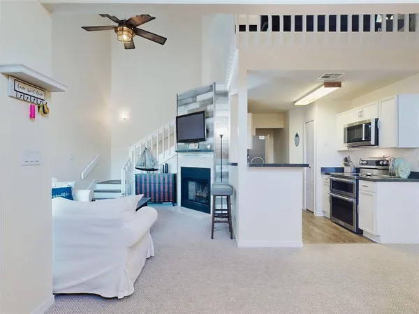a living room with furniture fireplace and flat screen tv