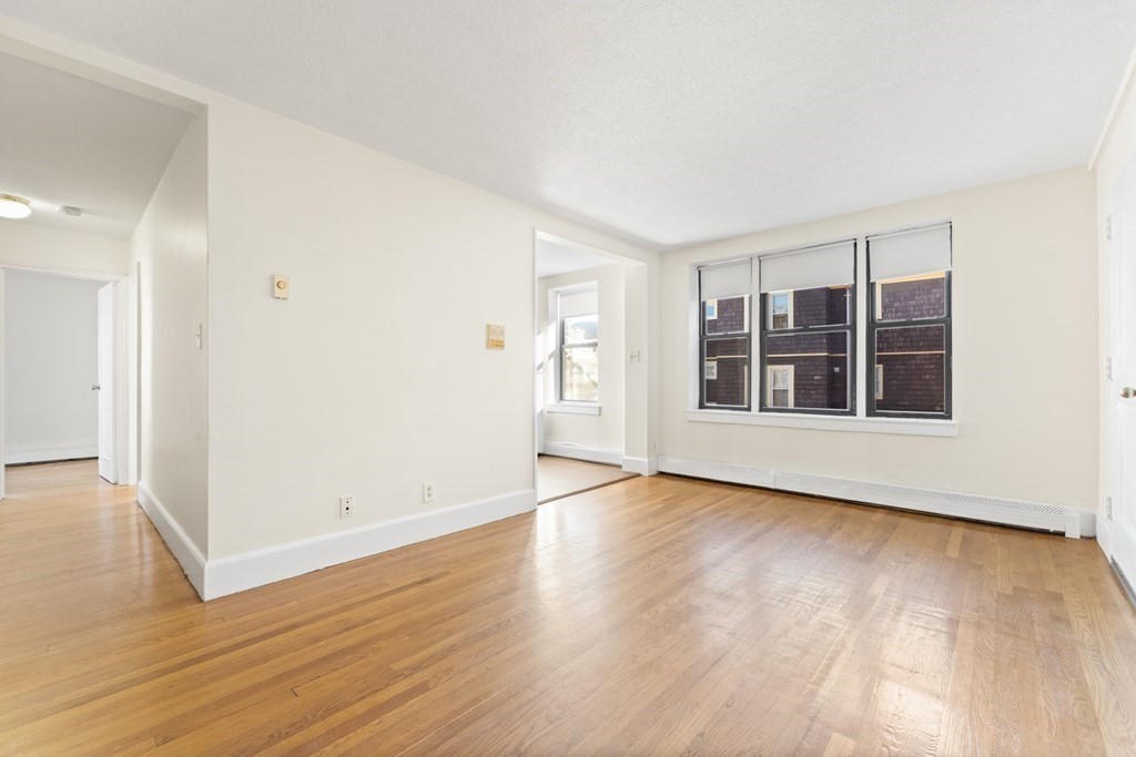 11 Victory Road, Unit 32 Boston, MA 02122 - Photo 12 of 16 wooden floor in an empty room