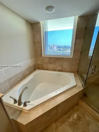 a bath tub sitting in a bathroom next to a window