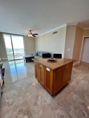 a kitchen with a stove top oven and cabinets