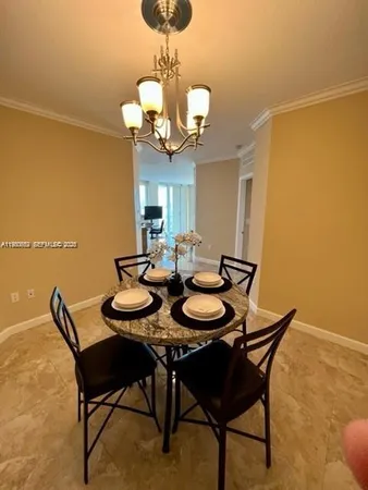 a view of a dining room with furniture and chandelier