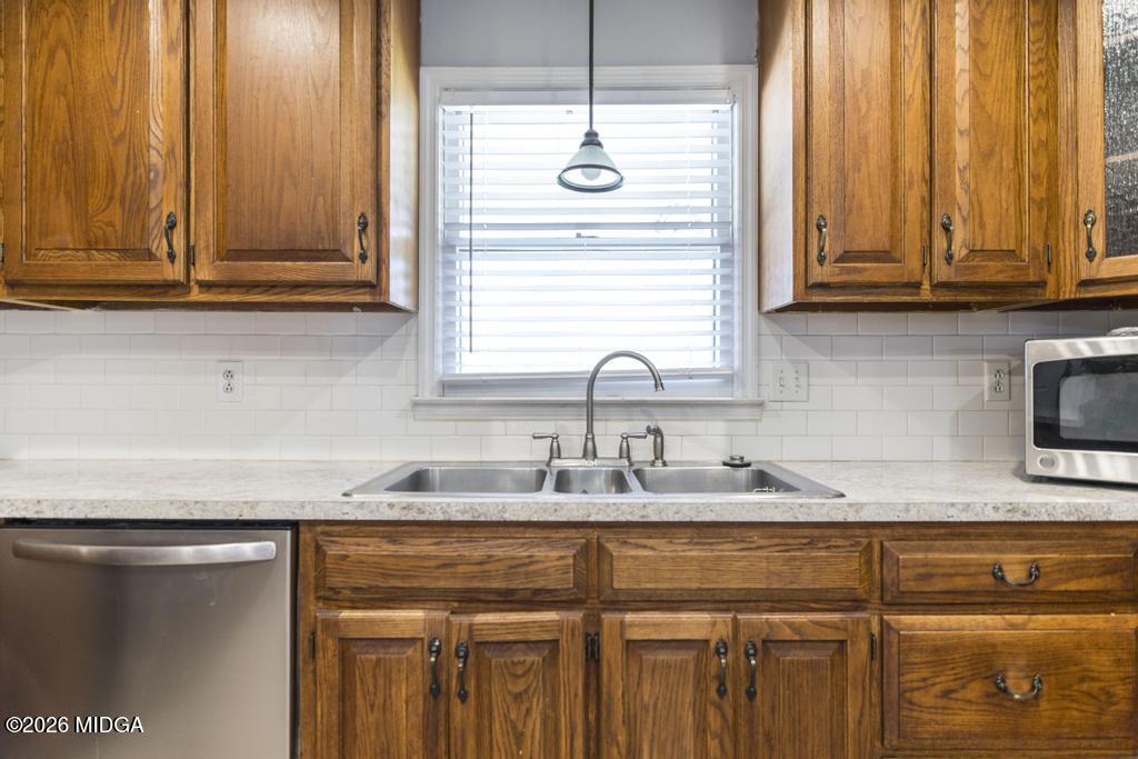 3710 Sandy Circle Macon, GA 31216 - Photo 14 of 44 a kitchen with granite countertop cabinets sink and window