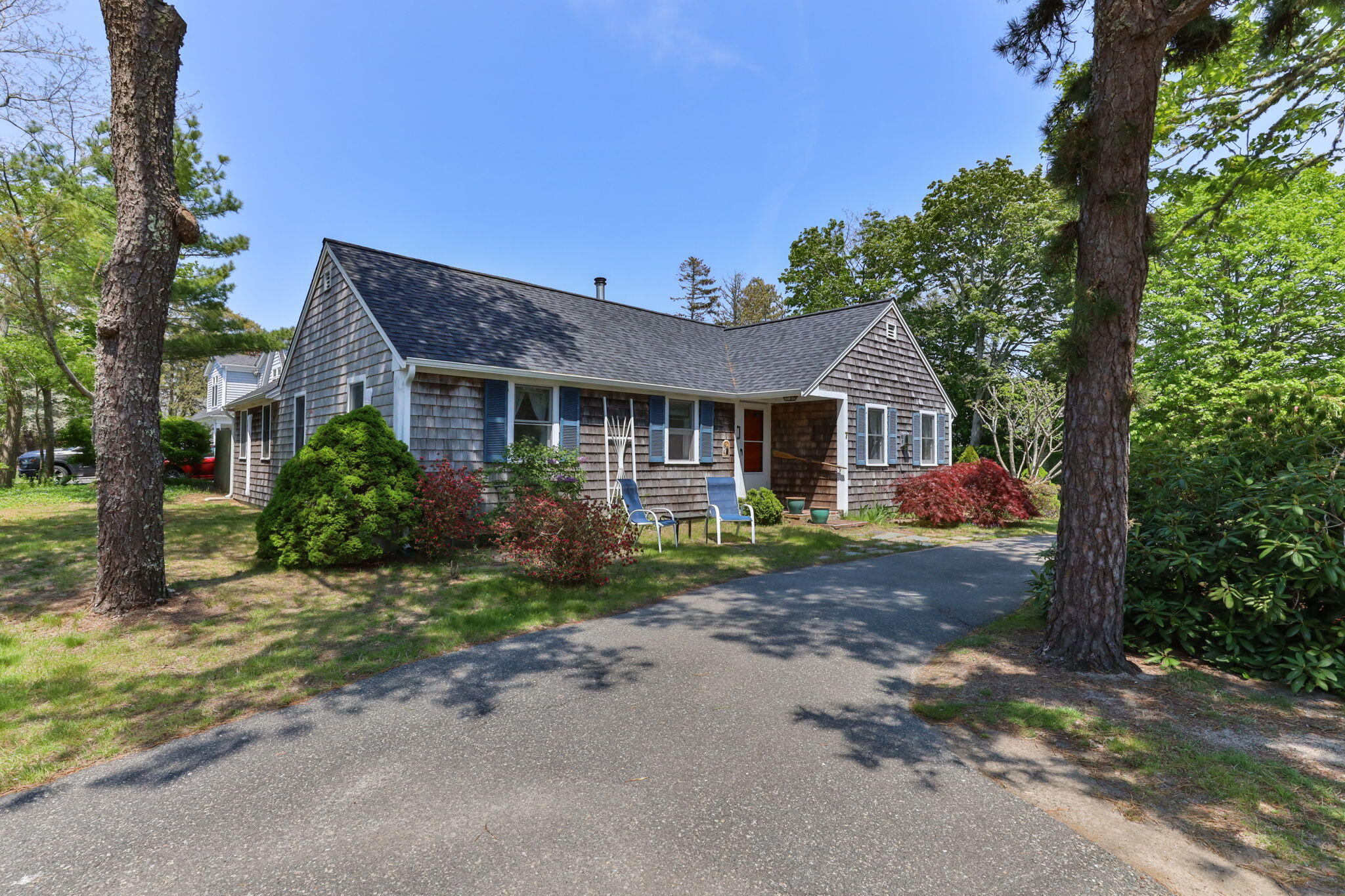 7 Aunt Matties Road Chatham, MA 02633 - Photo 1 of 37 a front view of a house with a garden