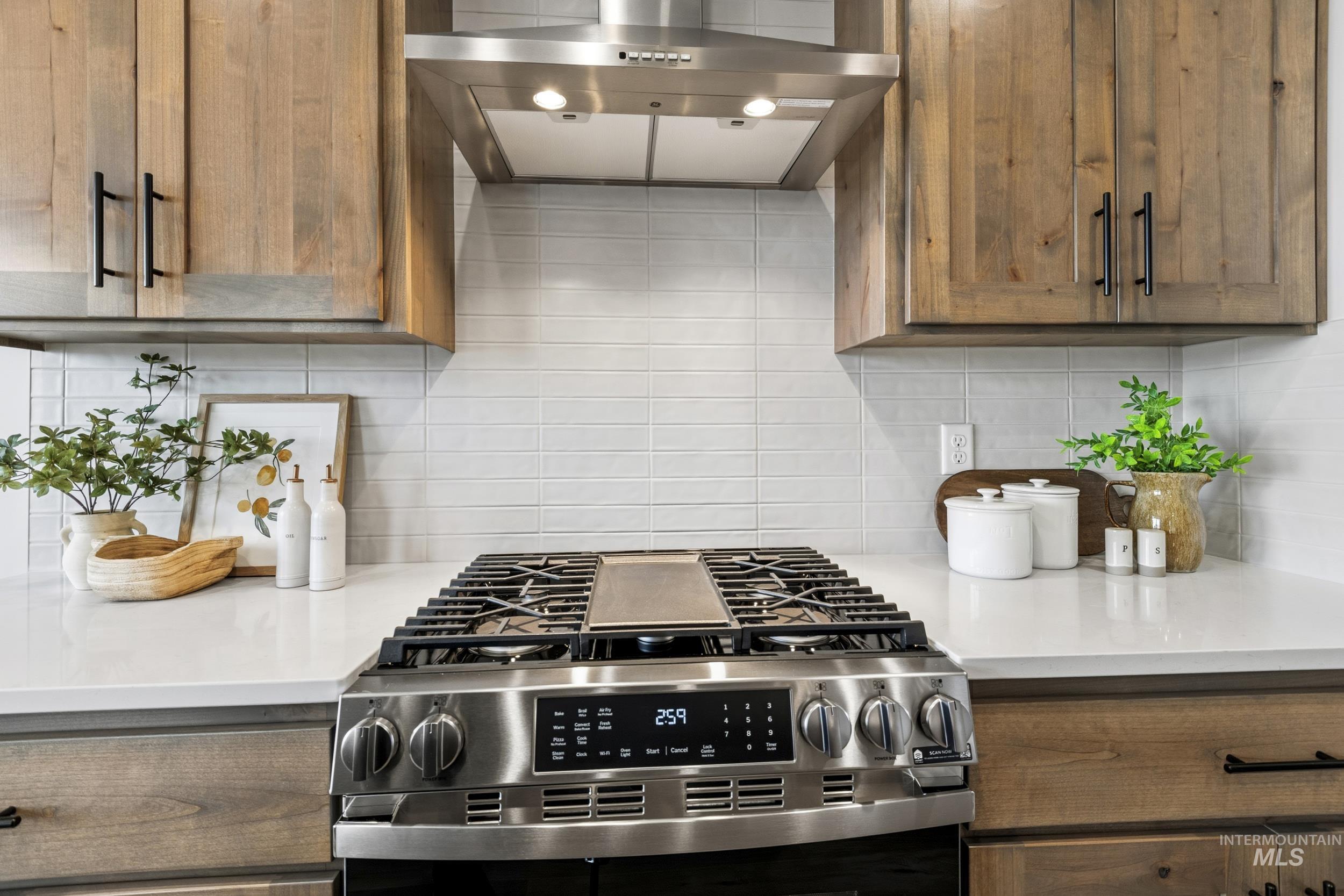 1988 West Bittern Street Nampa, ID 83686 - Photo 21 of 34 Kitchen featuring extractor fan, gas stove, and backsplash