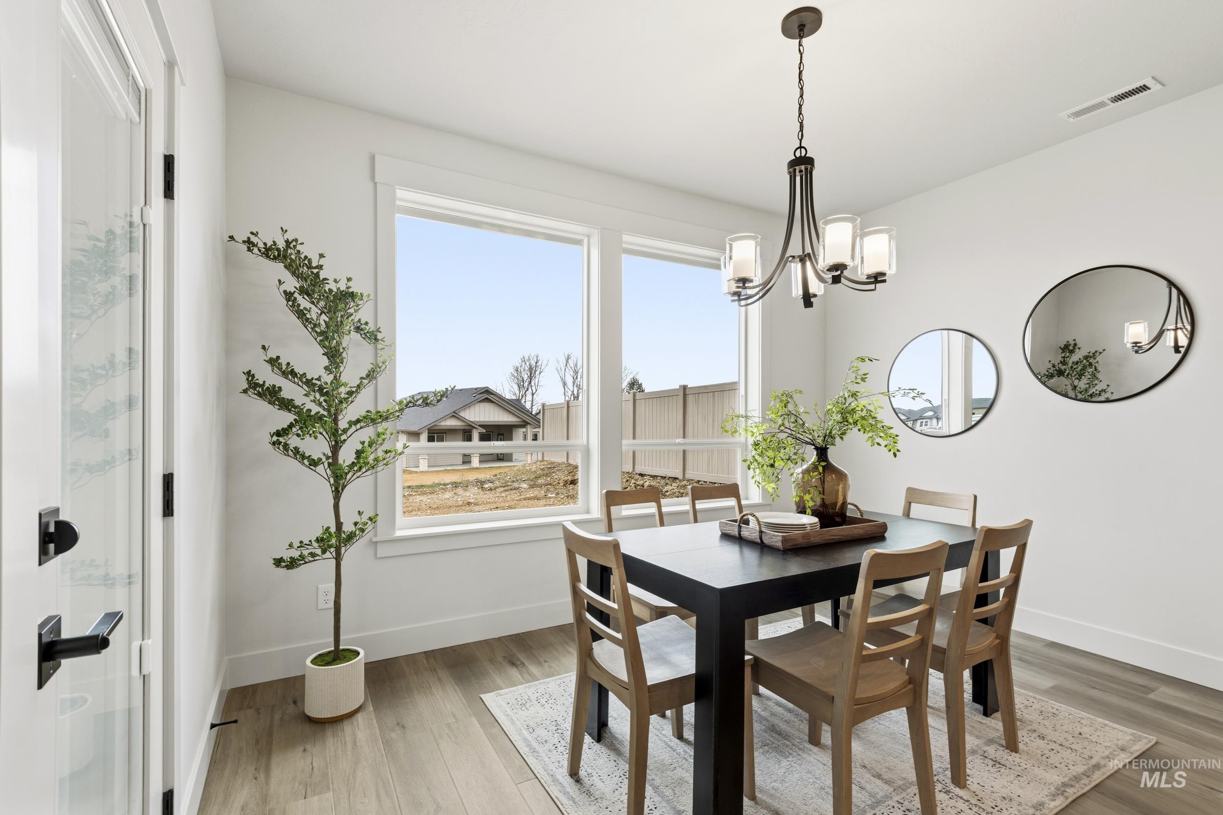 1988 West Bittern Street Nampa, ID 83686 - Photo 23 of 34 Dining room featuring light wood-style flooring and hanging lights