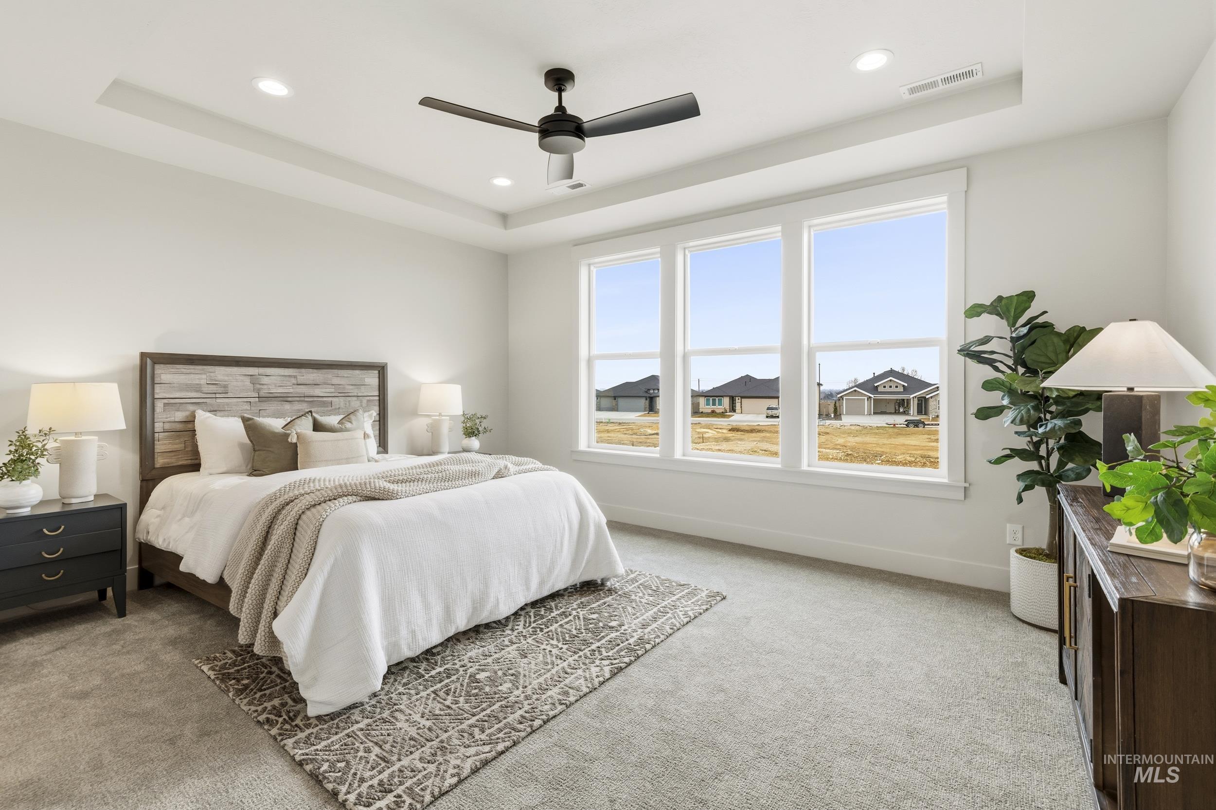 1988 West Bittern Street Nampa, ID 83686 - Photo 24 of 34 Bedroom featuring light carpet, a ceiling fan, a tray ceiling, and recessed lighting