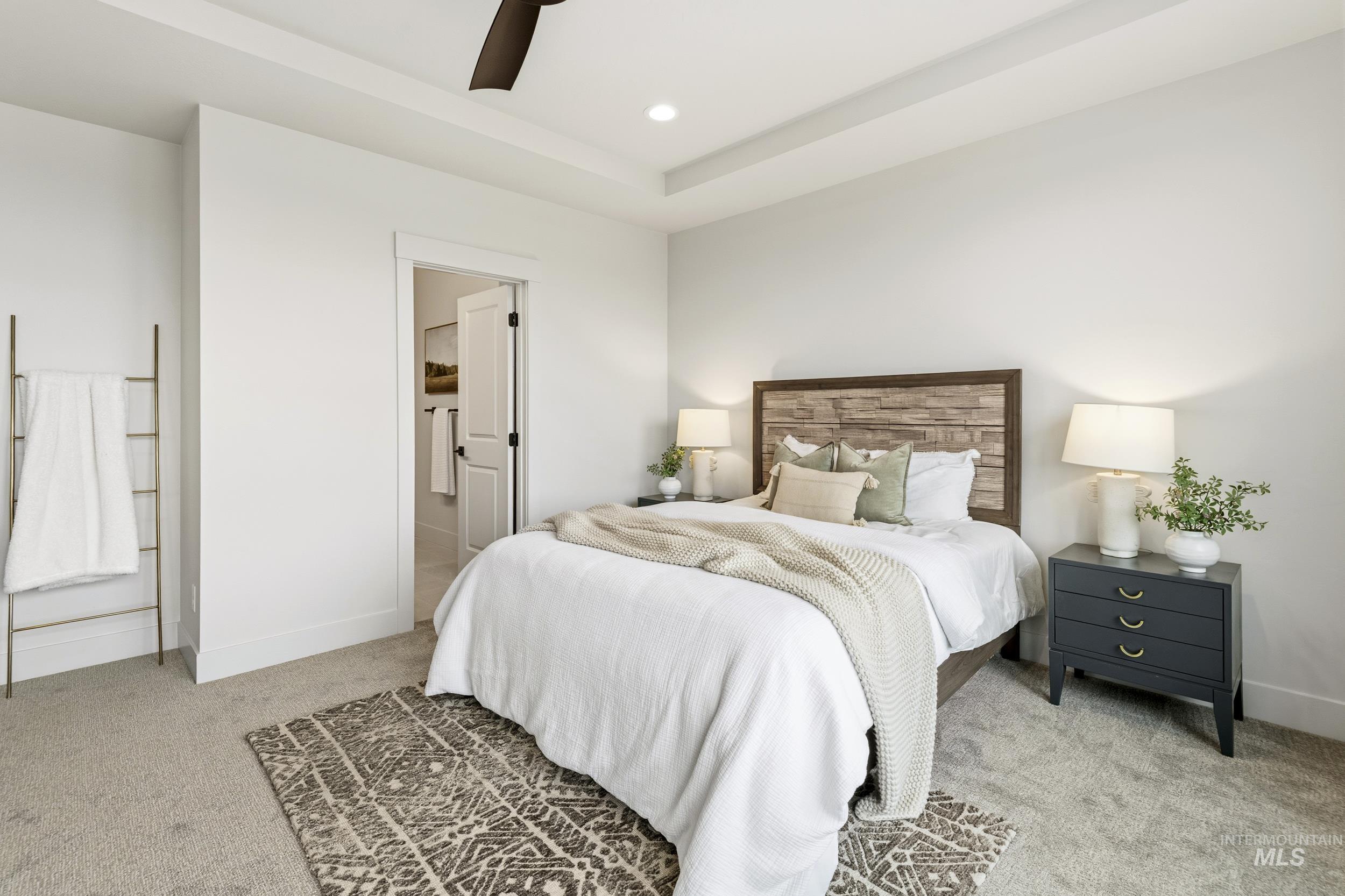 1988 West Bittern Street Nampa, ID 83686 - Photo 25 of 34 Bedroom with light colored carpet, connected bathroom, ceiling fan, recessed lighting, and a raised ceiling