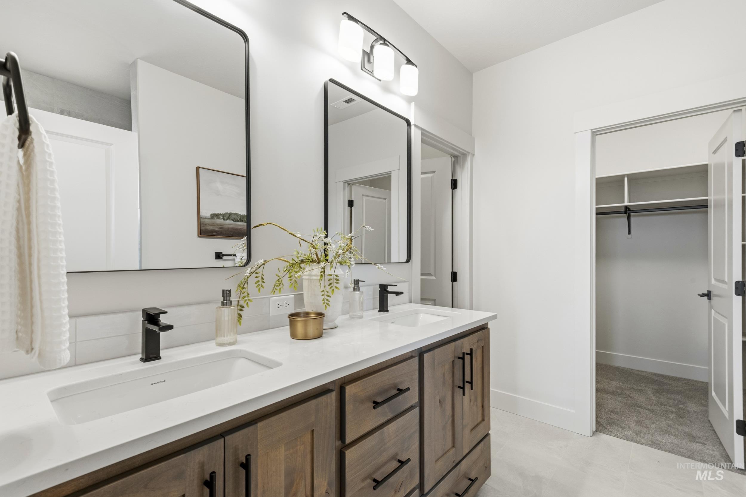 1988 West Bittern Street Nampa, ID 83686 - Photo 26 of 34 Bathroom featuring double vanity and a walk in closet