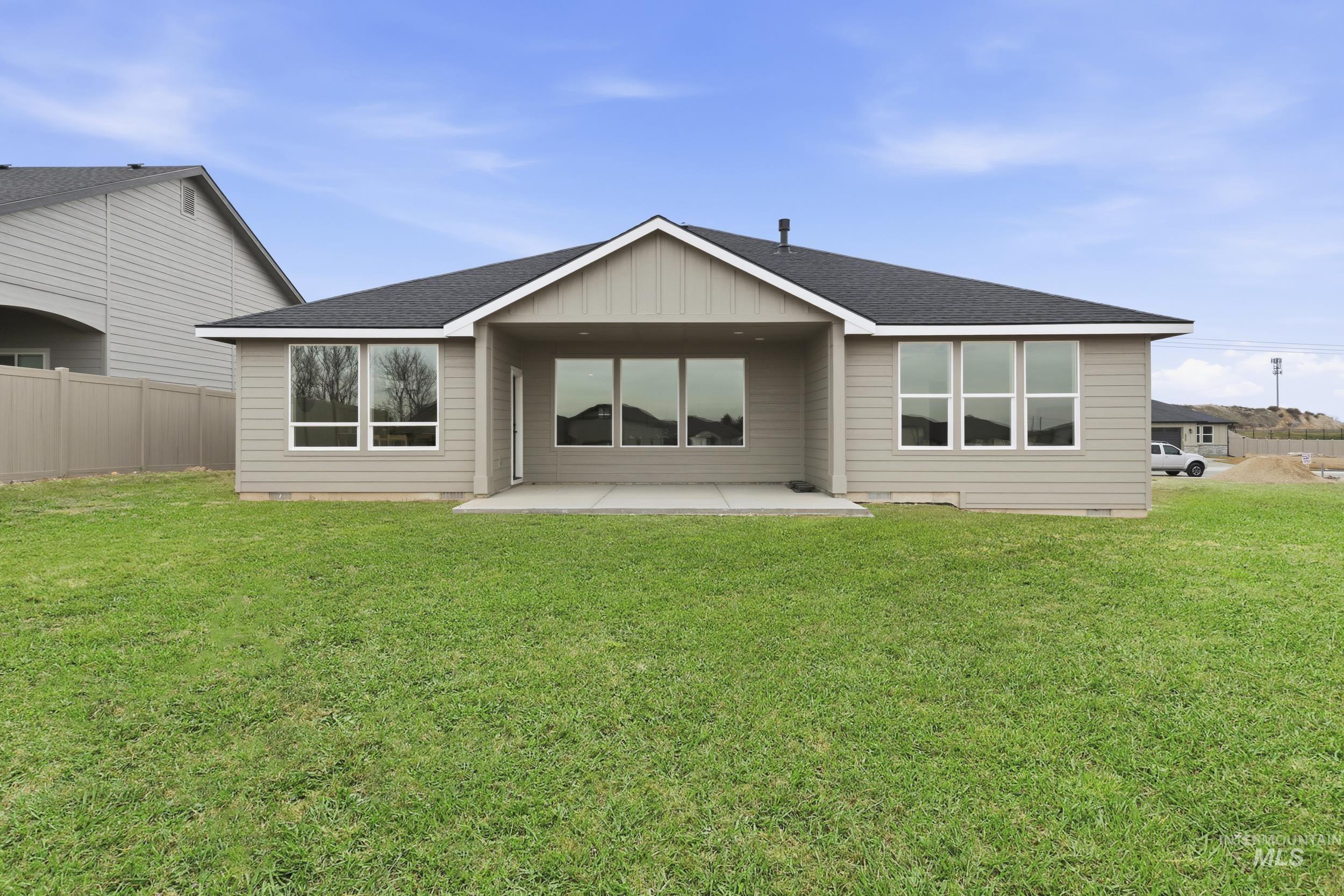 1988 West Bittern Street Nampa, ID 83686 - Photo 32 of 34 Back of house with a shingled roof, a patio, and board and batten siding
