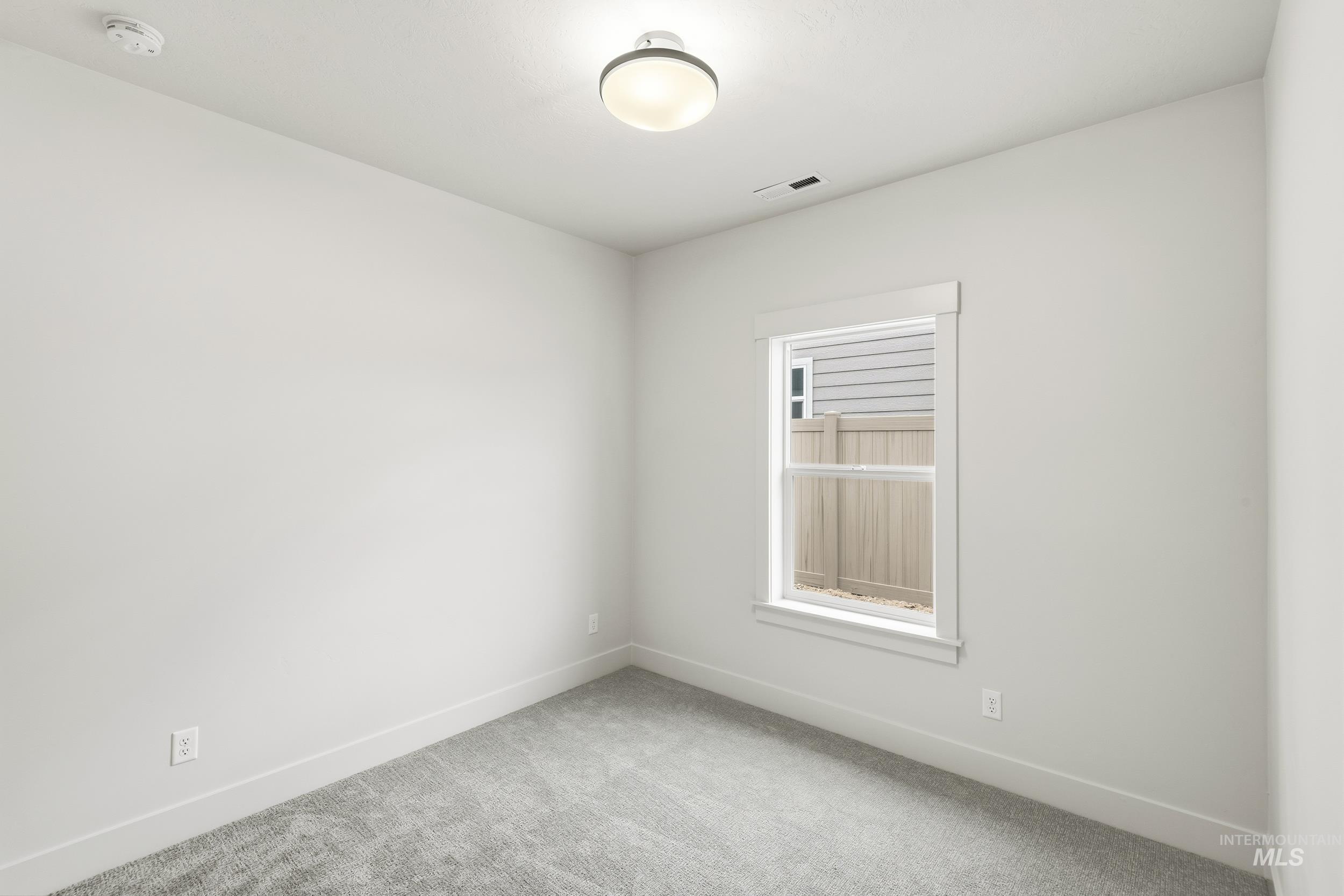 1988 West Bittern Street Nampa, ID 83686 - Photo 9 of 34 Carpeted spare room featuring baseboards