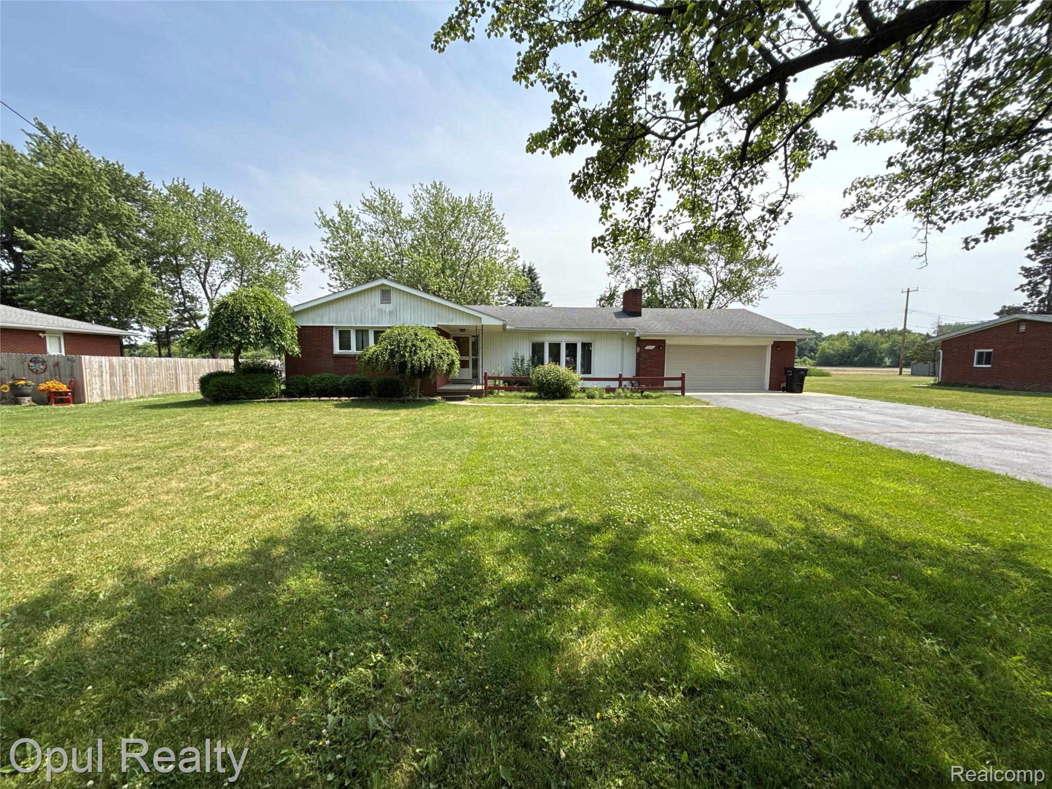 7899 Ida East Road Ida, MI 48140 - Photo 3 of 48 Ranch-style residence featuring a brick facade with white siding and a covered front porch