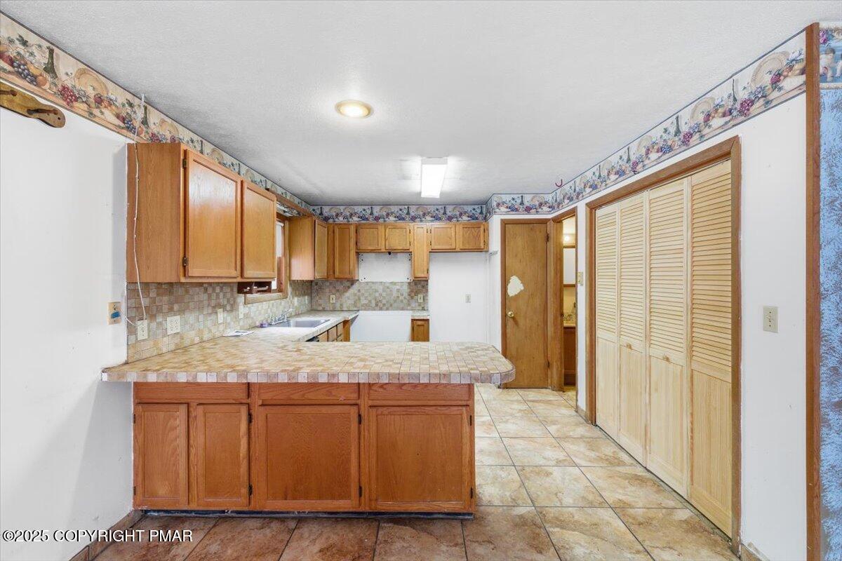 5695 Decker Road Bushkill, PA 18324 - Photo 11 of 29 a bathroom with a granite countertop sink and a mirror