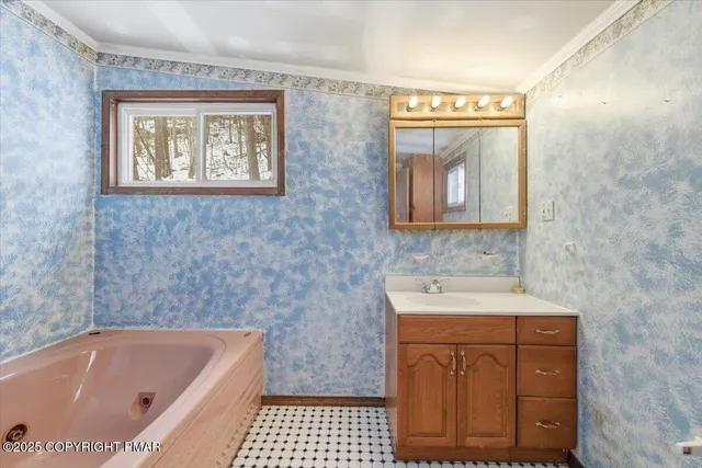 a bathroom with a sink a bathtub and a window