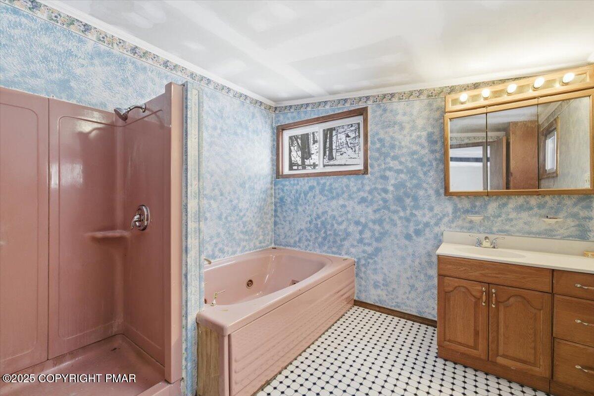5695 Decker Road Bushkill, PA 18324 - Photo 18 of 29 a bathroom with a bathtub and a sink