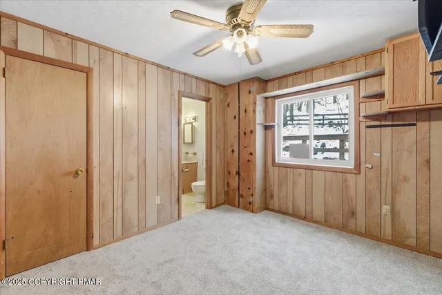 a view of a hallway with a chandelier fan