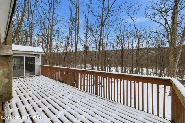 a view of balcony with wooden floor and fence