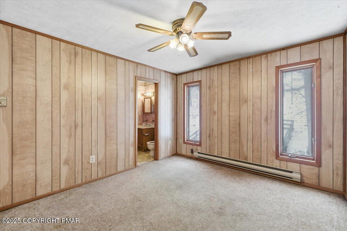 5695 Decker Road Bushkill, PA 18324 - Photo 25 of 29 an empty room with windows and a chandelier fan