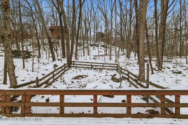 a view of a wooden fence and trees