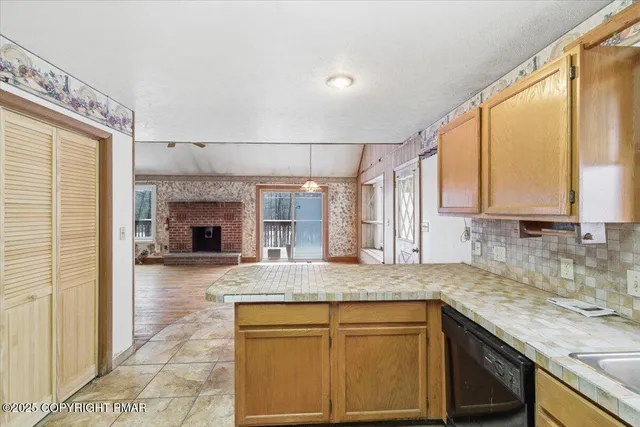 a kitchen with kitchen island granite countertop a sink cabinets and window
