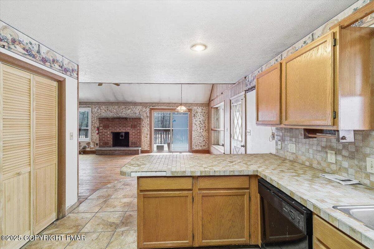 5695 Decker Road Bushkill, PA 18324 - Photo 9 of 29 a kitchen with kitchen island granite countertop a sink cabinets and window