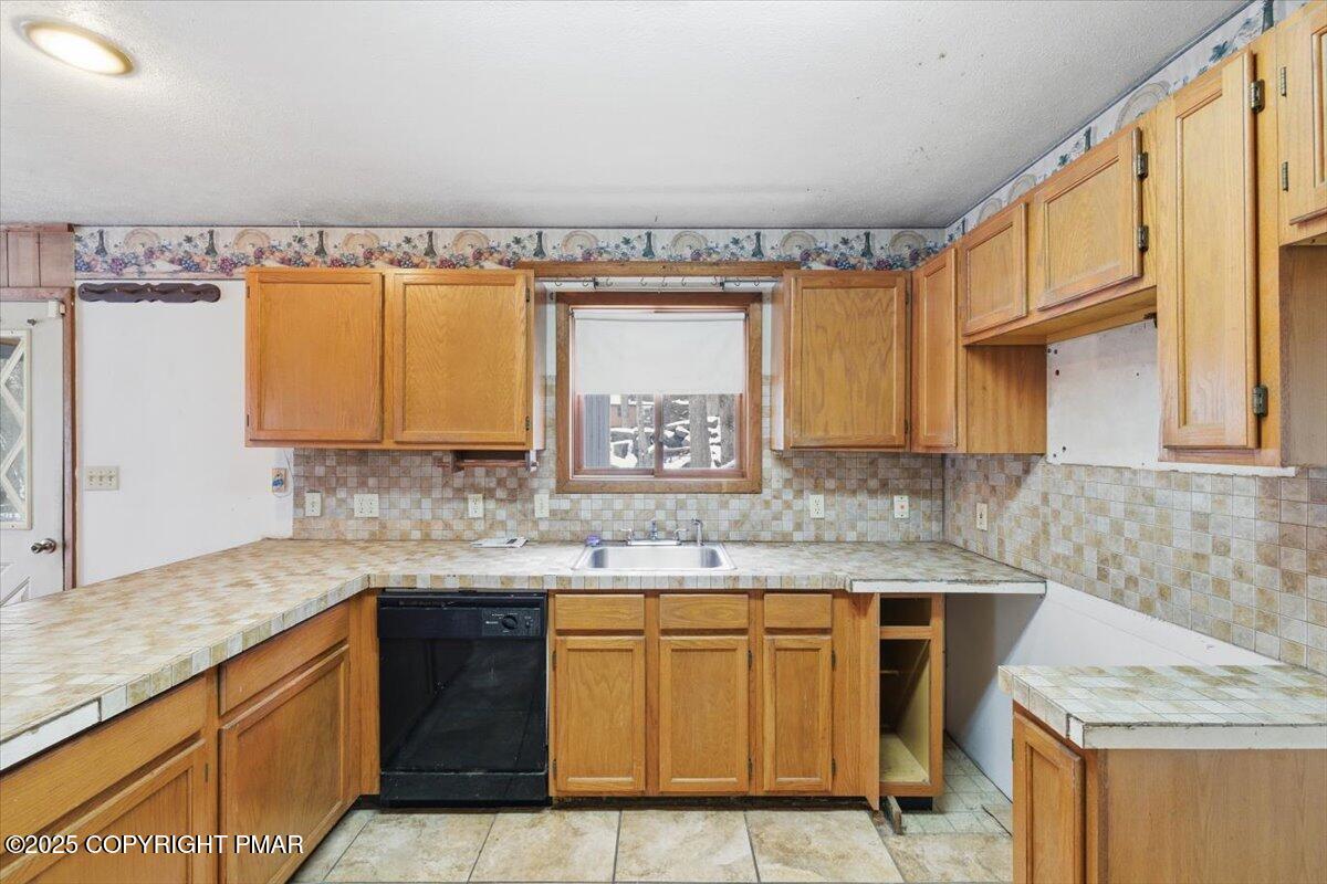 5695 Decker Road Bushkill, PA 18324 - Photo 10 of 29 a kitchen with granite countertop a sink a stove and cabinets