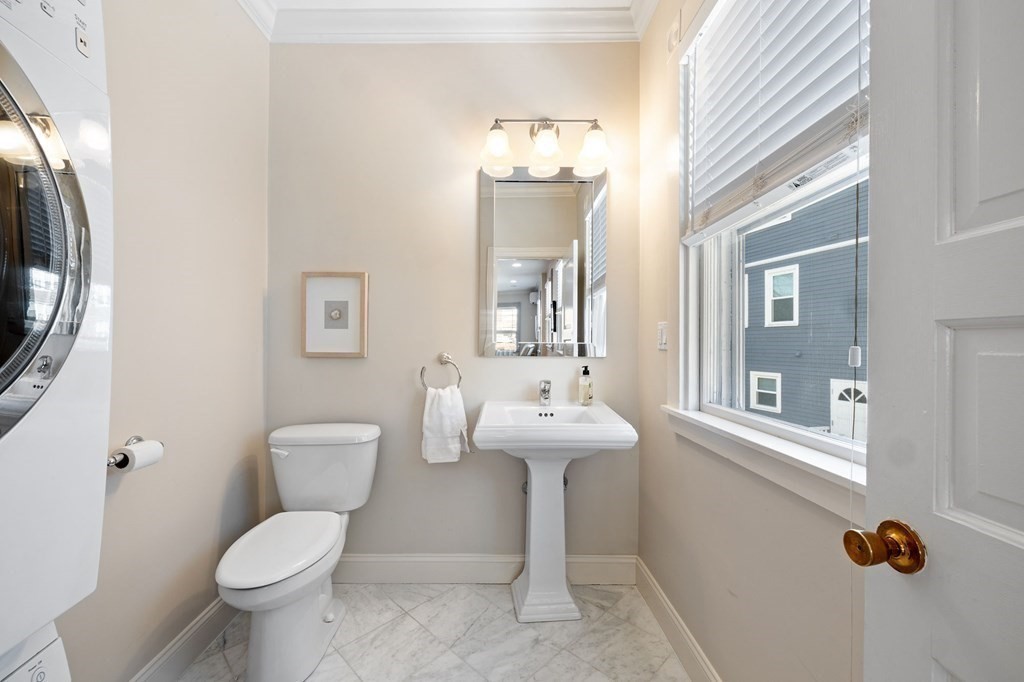 12 Colliston Road, Unit 2 Boston, MA 02135 - Photo 6 of 10 a bathroom with a toilet sink and mirror