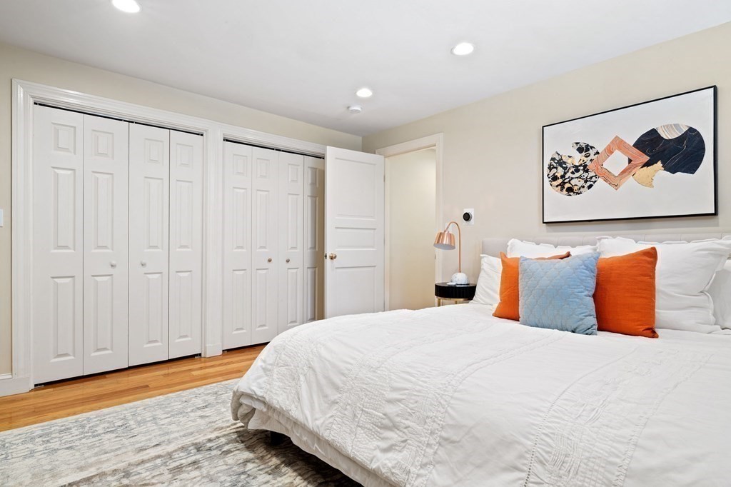 12 Colliston Road, Unit 2 Boston, MA 02135 - Photo 7 of 10 a spacious bedroom with a bed and a painting on the wall