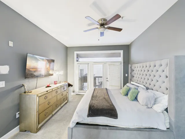 a bedroom with a bed and a chandelier