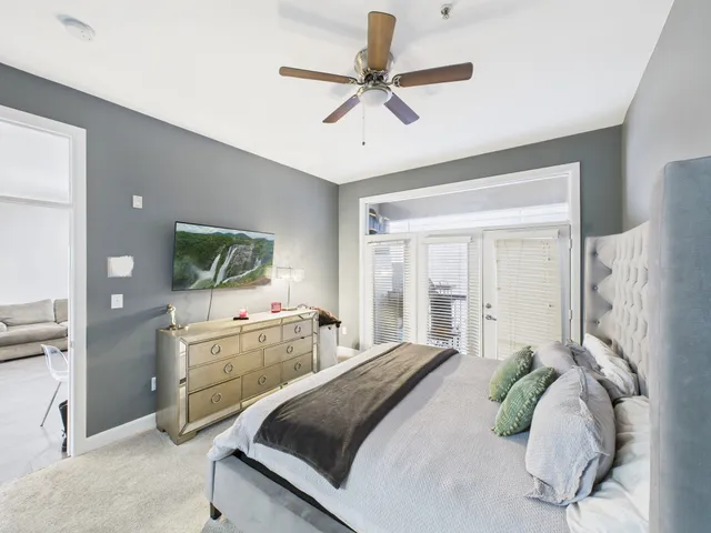 a bedroom with a large bed and a chandelier