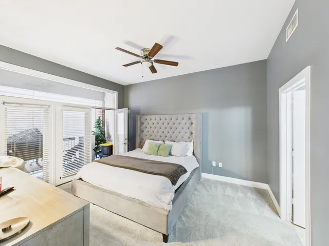 a bedroom with a large bed and a large window