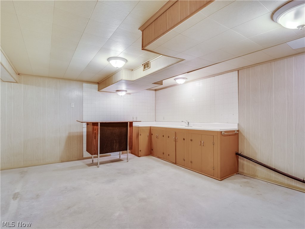 1047 Roland Road Lyndhurst, OH 44124 - Photo 22 of 26 Full Basement provides a lot of storage, features finished walls and ceiling and a kitchenette with a sink.
