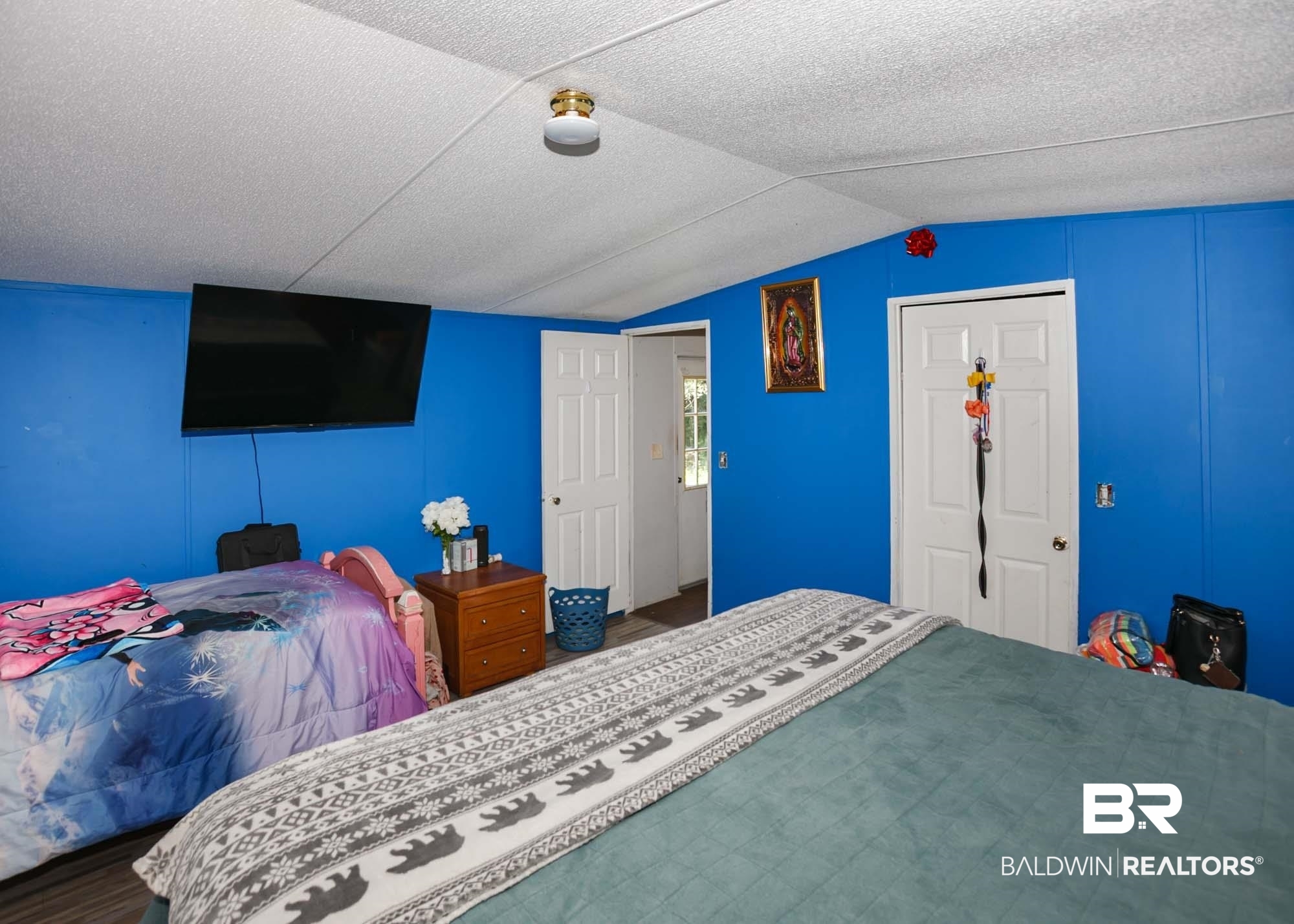 14005 County Road 49 Foley, AL 36535 - Photo 16 of 38 Bedroom with vaulted ceiling, wood finished floors, and a textured ceiling