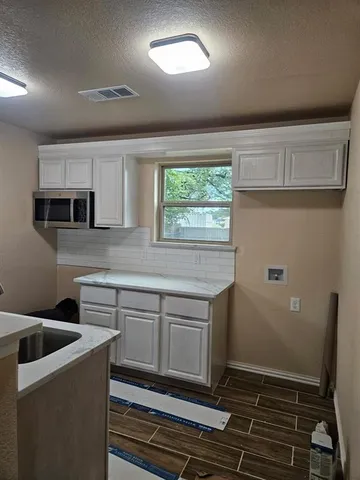a kitchen with stainless steel appliances a stove a sink and a microwave