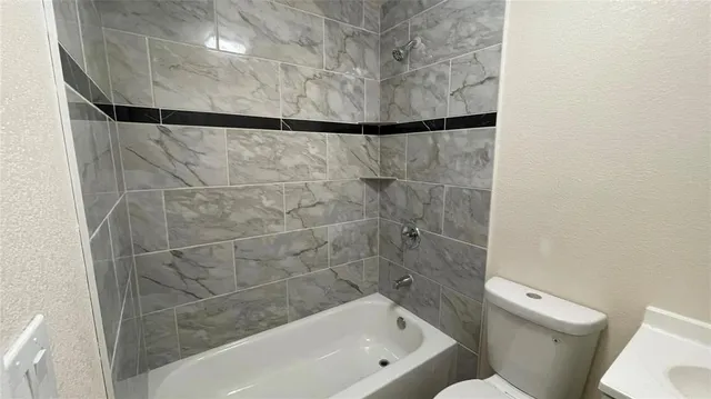a bathroom with a bathtub and a toilet