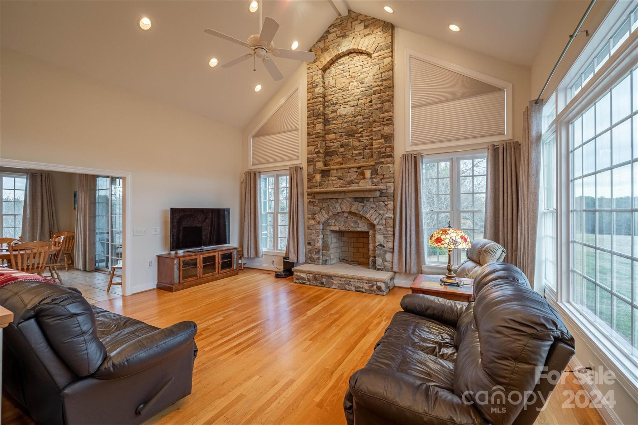 3292 Deal Mill Road Hudson, NC 28638 - Photo 8 of 44 a living room with furniture a fireplace and a flat screen tv