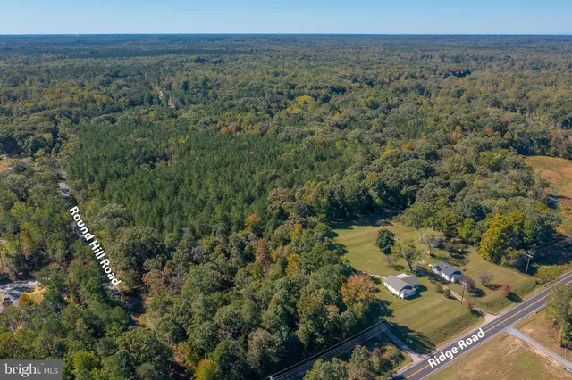 an aerial view of a residential houses with outdoor space