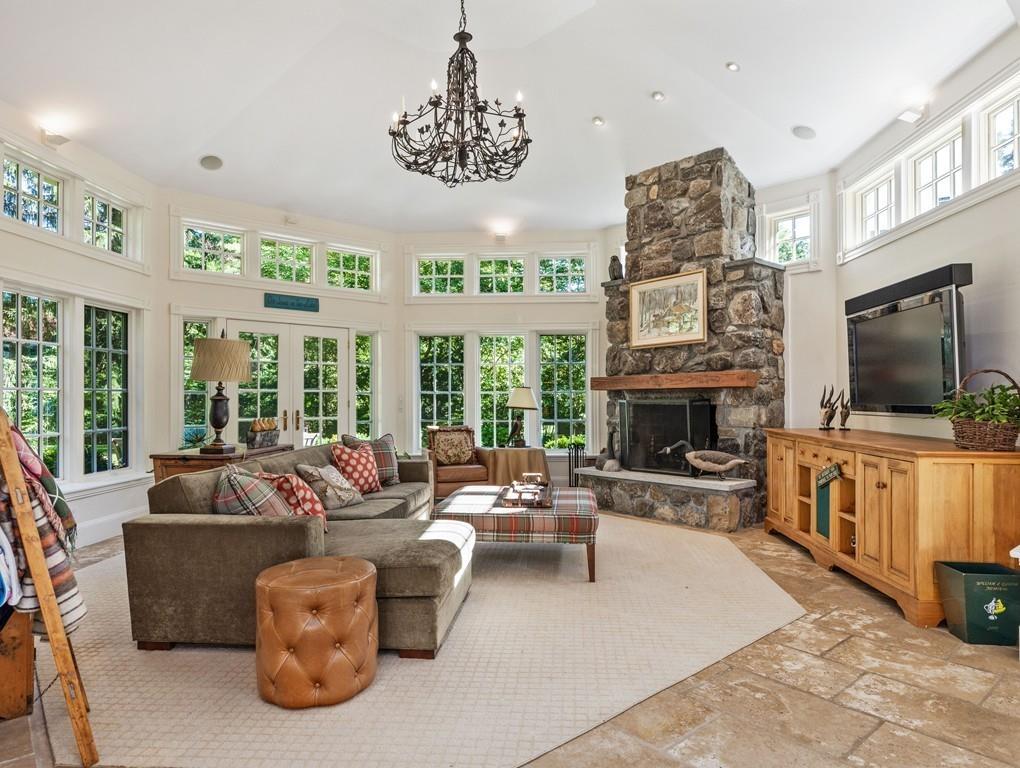 101 Abbott Road Wellesley, MA 02481 - Photo 18 of 38 a living room with furniture a flat screen tv and a fireplace
