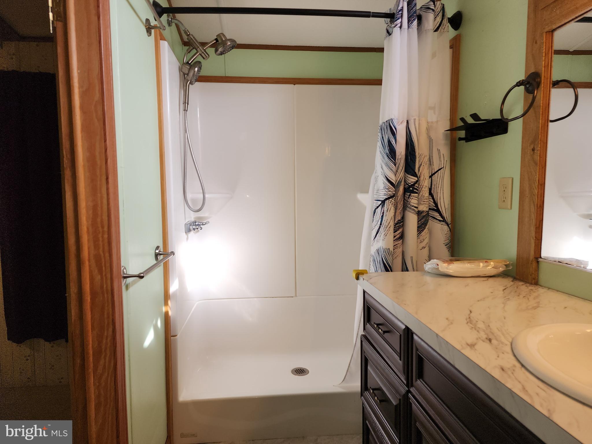 11 Ridgewood Manor Manheim, PA 17545 - Photo 29 of 37 a bathroom with a granite countertop sink a mirror and shower