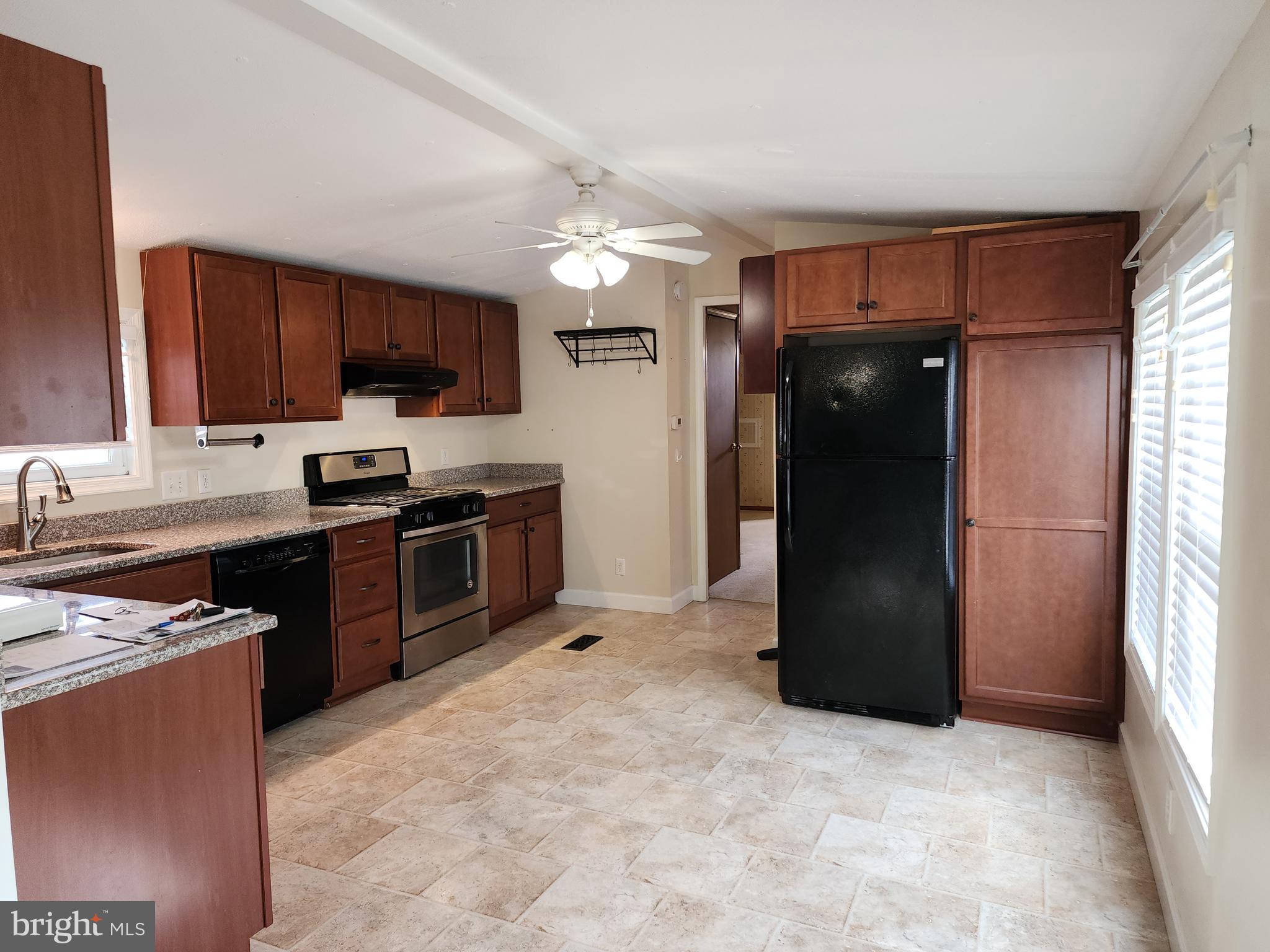 11 Ridgewood Manor Manheim, PA 17545 - Photo 7 of 37 a kitchen with kitchen island granite countertop a refrigerator stove top oven a sink and dishwasher