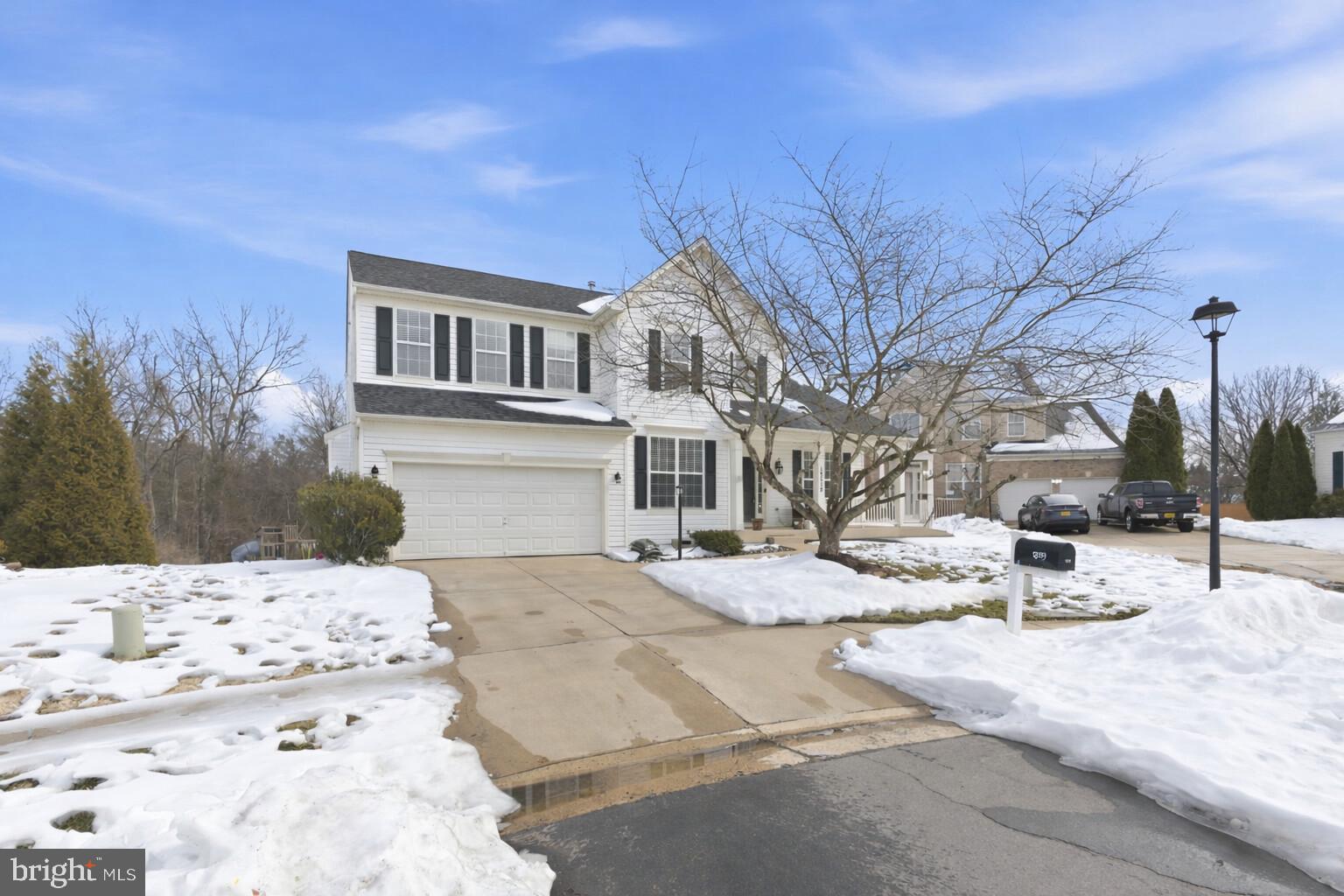 a view of a house with snow on the road