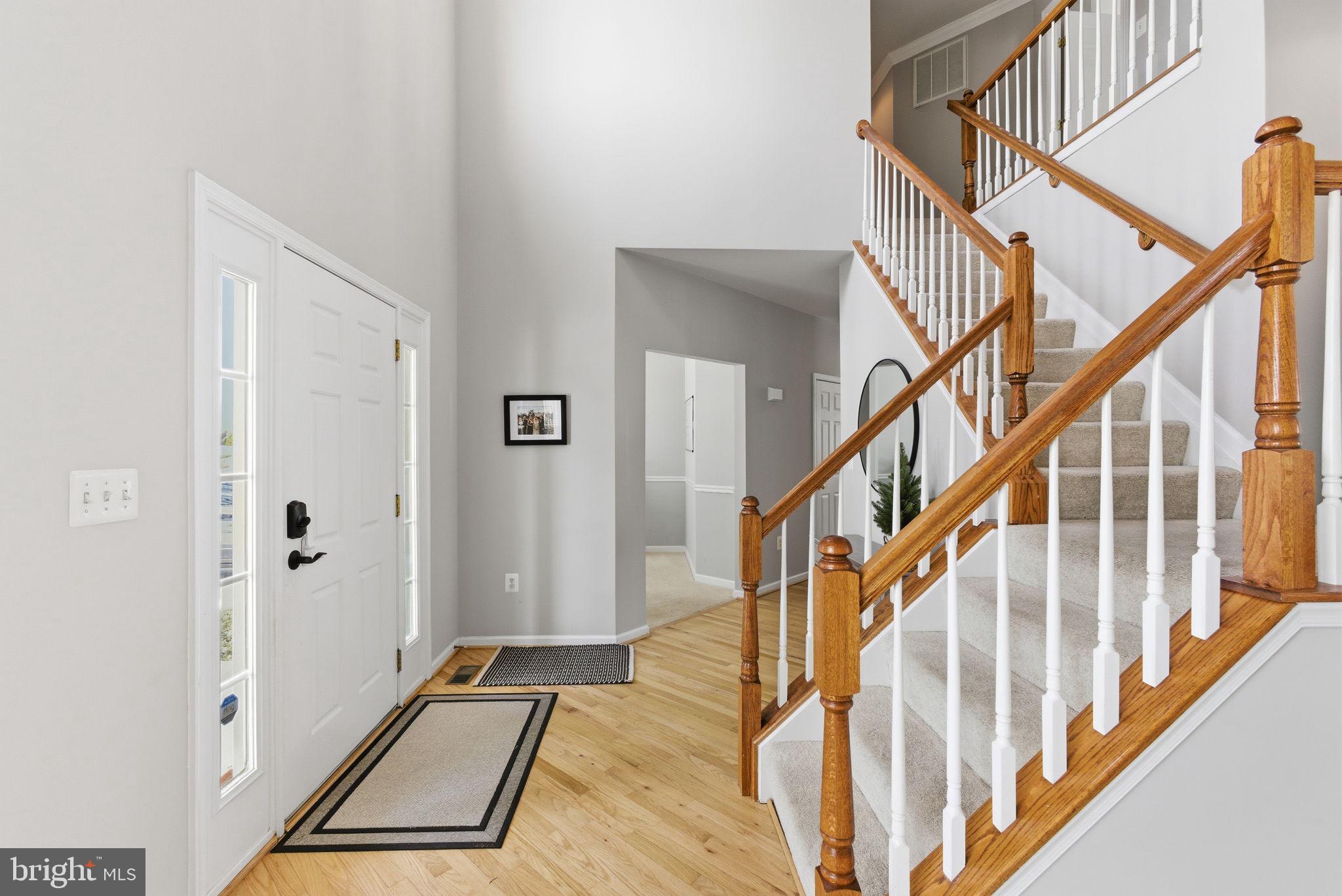 13119 Bigleaf Maple Court Gainesville, VA 20155 - Photo 19 of 36 a view of staircase with wooden floor and a rug